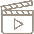 Filmklappe als Icon in beige auf weißem Hintergrund